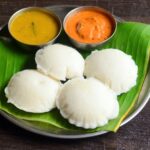 South Indian idli served with sambar and chutney.