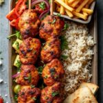 “Grilled chicken kebab platter with fries, salad and rice served in a Bangalore restaurant”