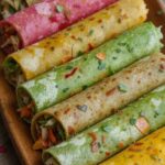 “Colorful vegetable rolls in green, yellow and pink wraps served fresh in a Bangalore restaurant”