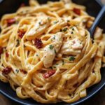 “Creamy chicken pasta with herbs and sun-dried tomatoes.”