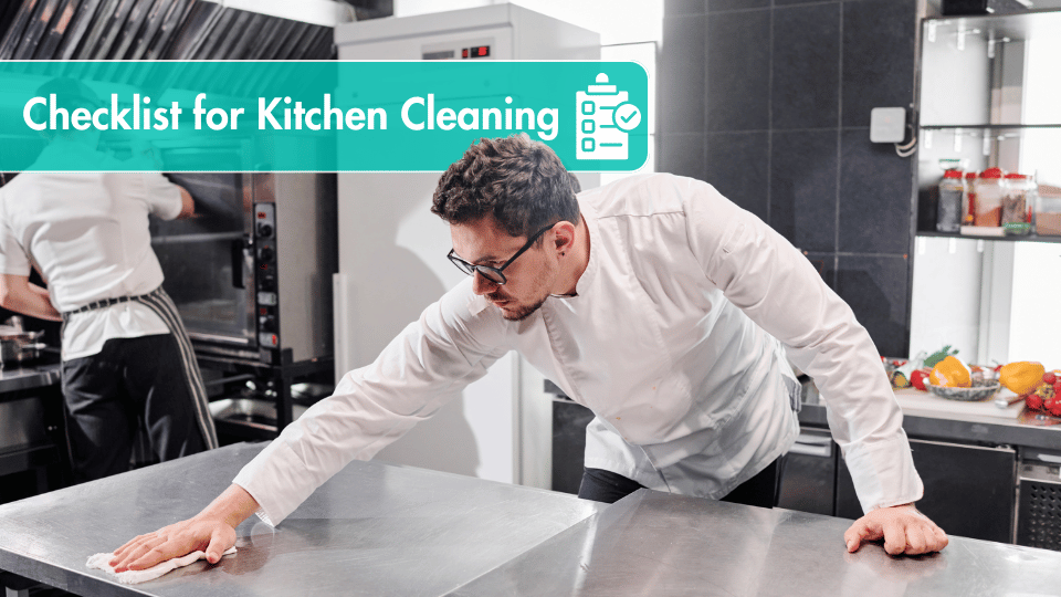 Chef sanitizing stainless steel kitchen counters to maintain top hygiene standards.