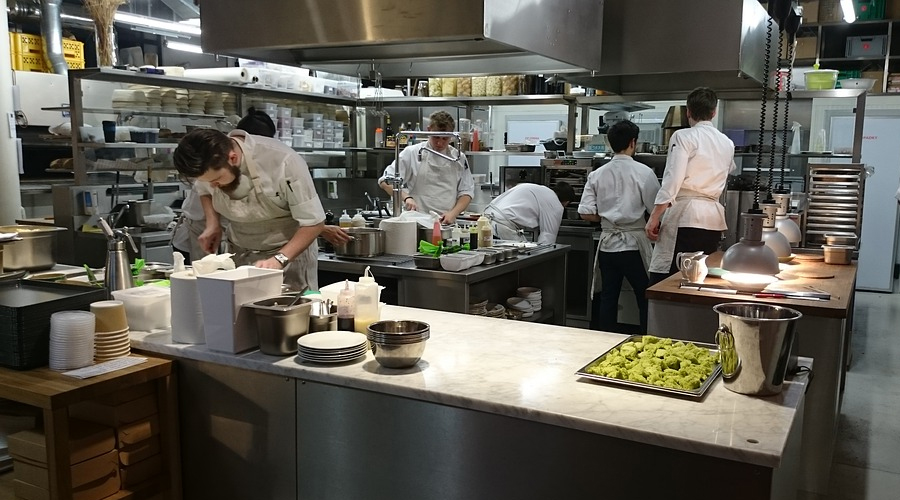 Chef inspecting fresh vegetables to ensure top-quality ingredients in the restaurant.